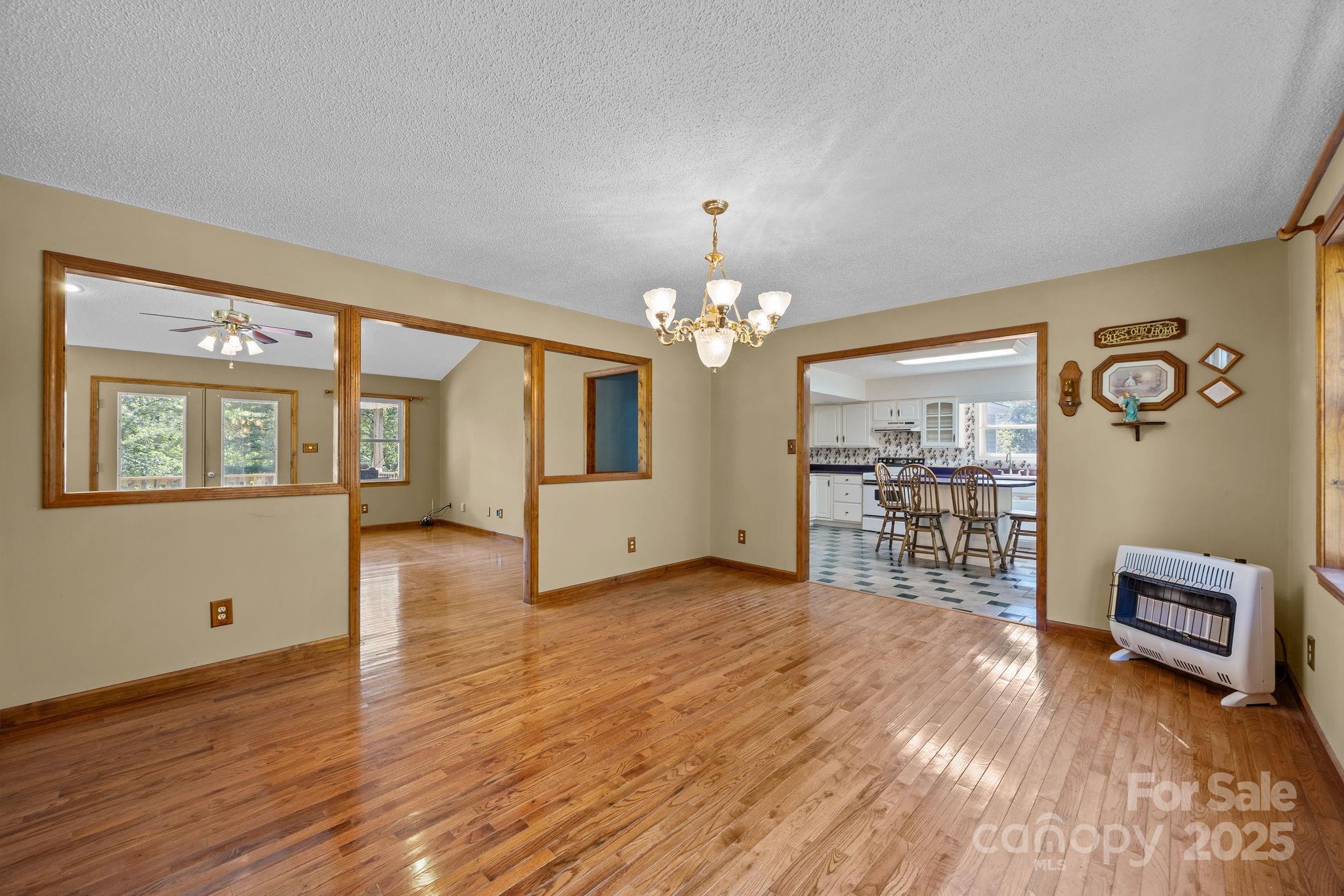 473 Eli Capps Road Zirconia, NC 28790 - Photo 13 of 37 a view of a livingroom with wooden floor and a ceiling fan