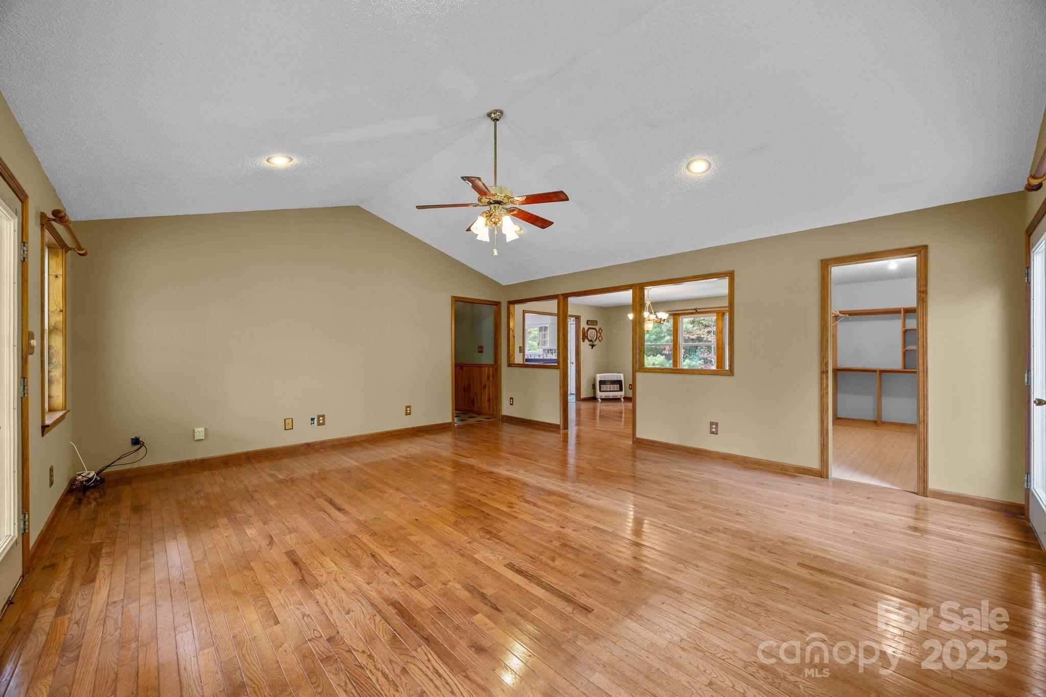 473 Eli Capps Road Zirconia, NC 28790 - Photo 16 of 37 wooden floor in an empty room with a window
