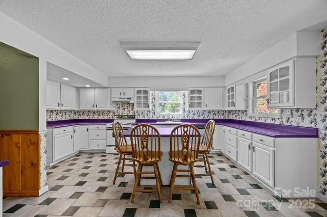a kitchen with stainless steel appliances a sink and cabinets