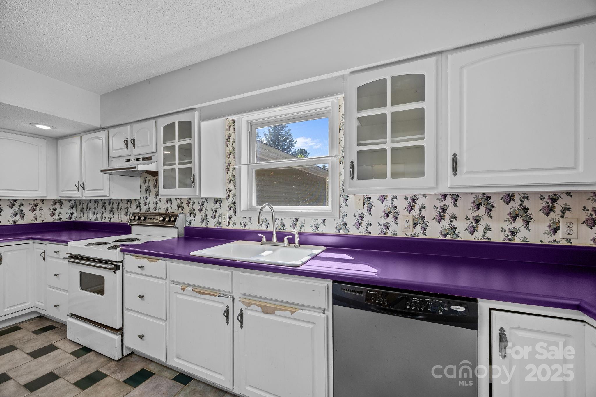473 Eli Capps Road Zirconia, NC 28790 - Photo 20 of 37 a kitchen with stainless steel appliances a sink and cabinets