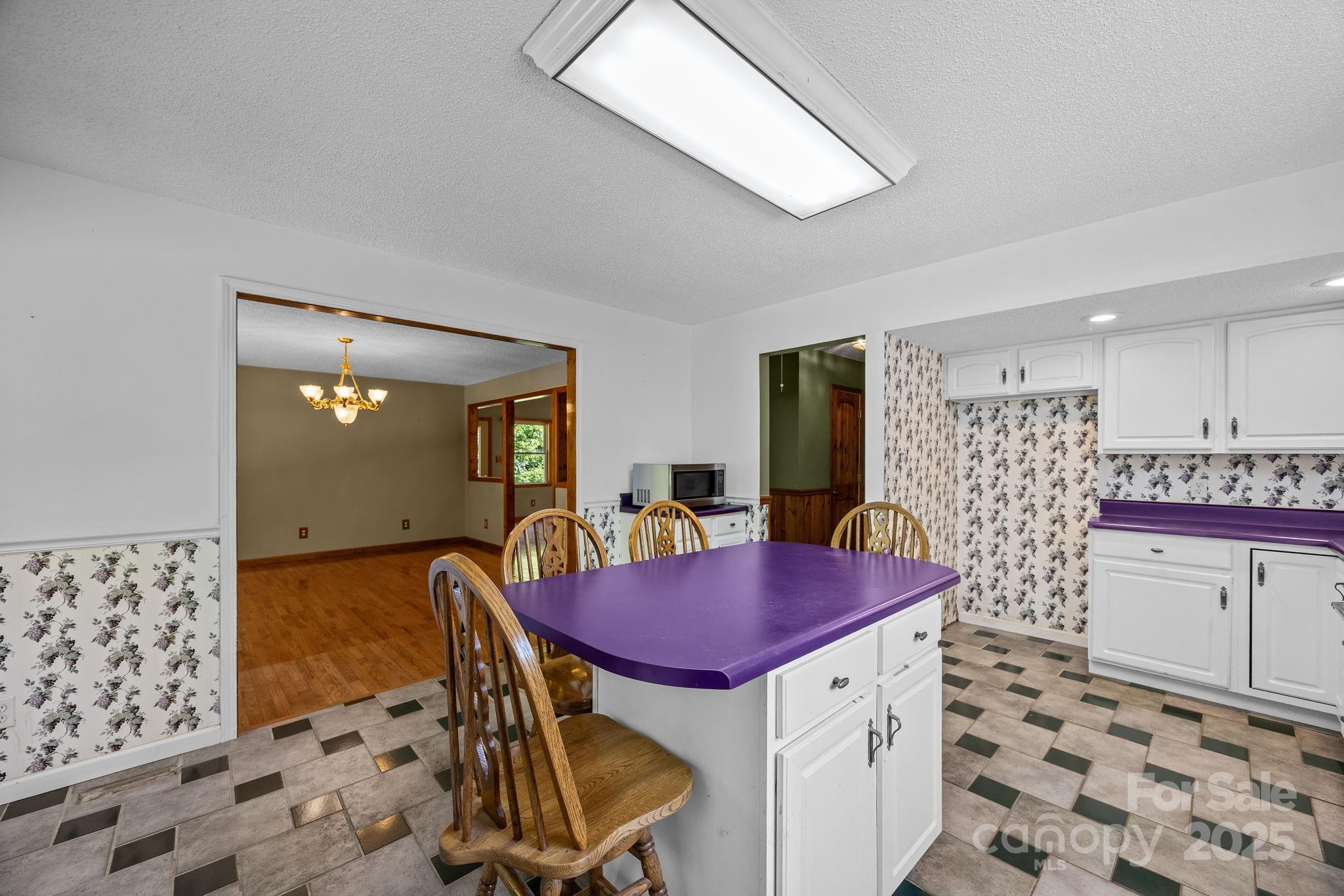 473 Eli Capps Road Zirconia, NC 28790 - Photo 21 of 37 a dining room with a table and chairs