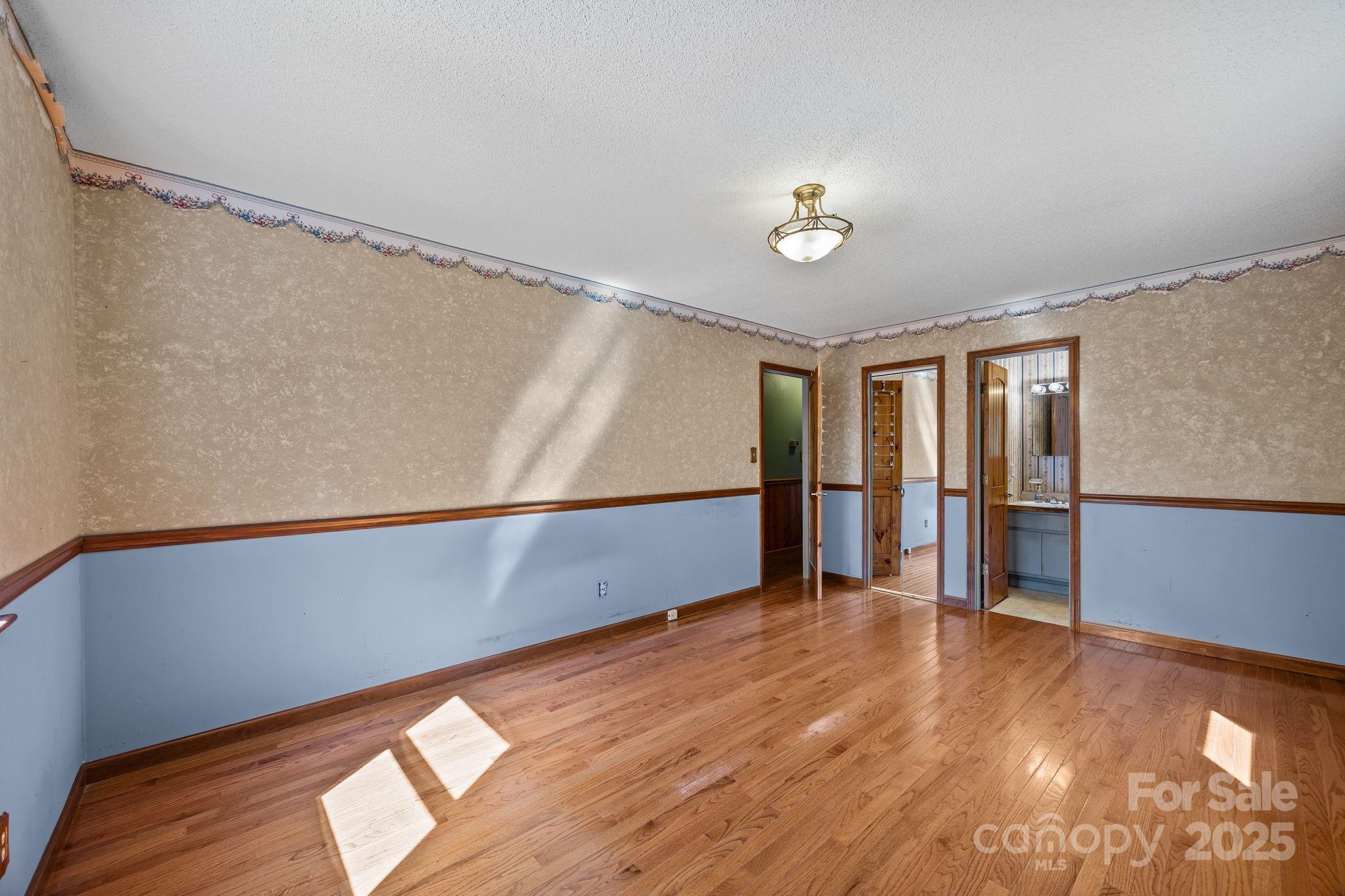 473 Eli Capps Road Zirconia, NC 28790 - Photo 23 of 37 a view of an empty room with wooden floor and a window