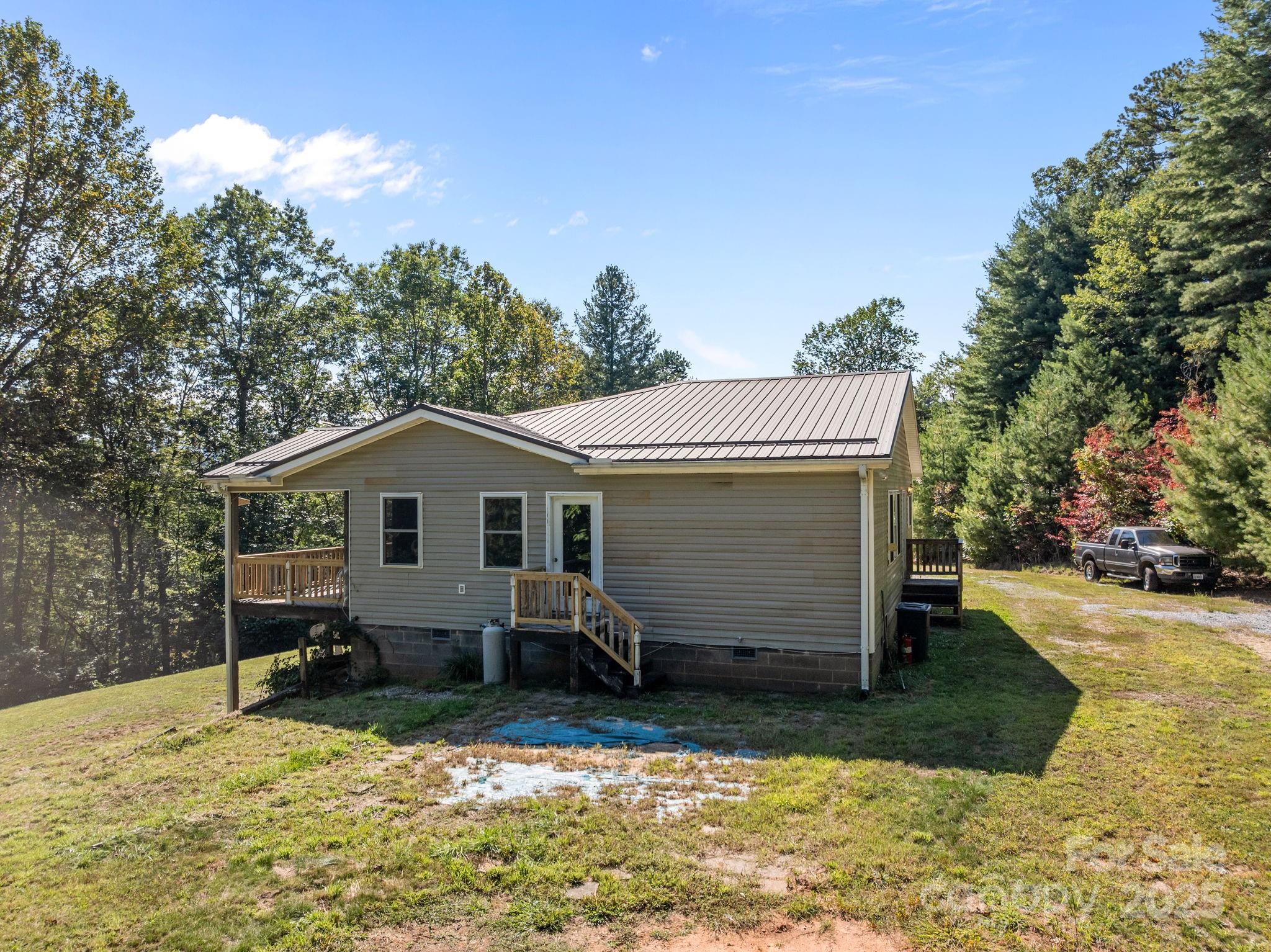 473 Eli Capps Road Zirconia, NC 28790 - Photo 5 of 37 a view of a house with a outdoor space