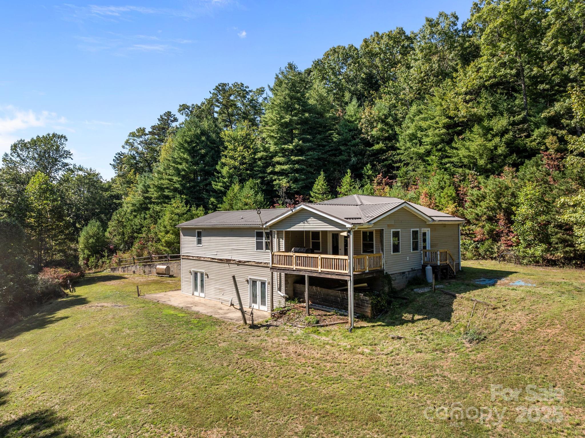 473 Eli Capps Road Zirconia, NC 28790 - Photo 6 of 37 a white house that has a tree in front of it