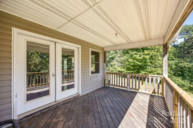 a view of a white house with a yard and large tree