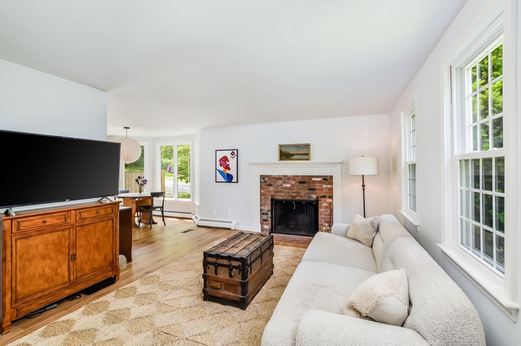 44 Buccaneer Way Mashpee, MA 02649 - Photo 14 of 39 a living room with furniture flat screen tv and a fireplace
