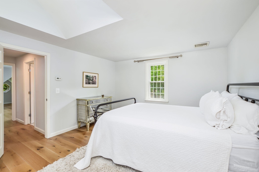 44 Buccaneer Way Mashpee, MA 02649 - Photo 26 of 39 a bedroom with a bed and wooden floor