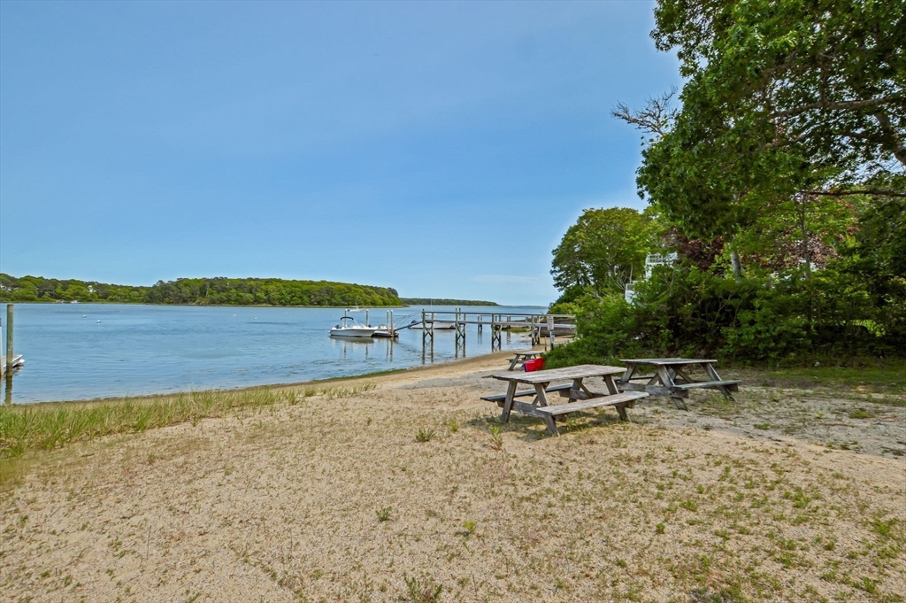 44 Buccaneer Way Mashpee, MA 02649 - Photo 34 of 39 a view of a lake with a house in the background