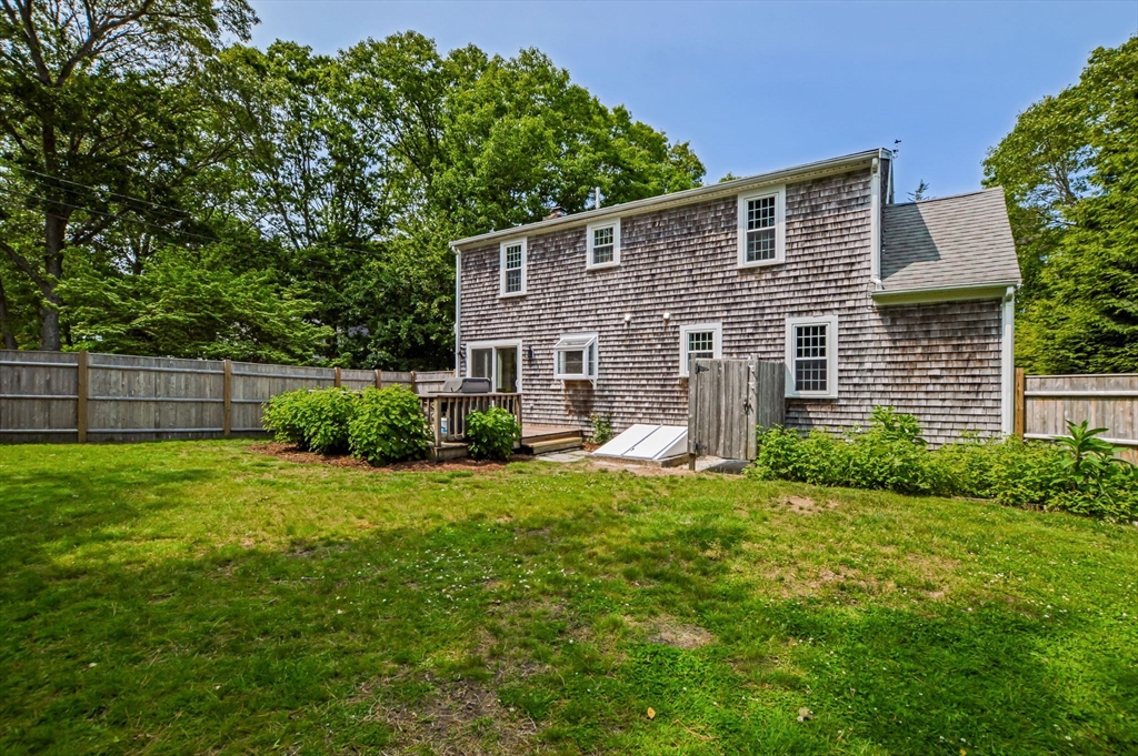 44 Buccaneer Way Mashpee, MA 02649 - Photo 6 of 39 a front view of a house with a yard and garage