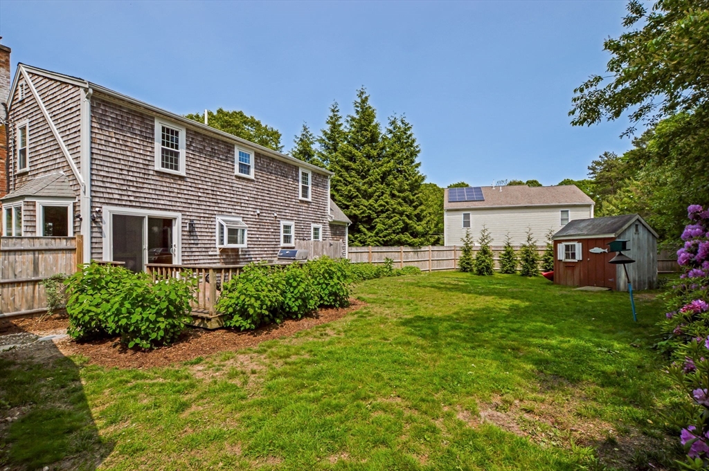 44 Buccaneer Way Mashpee, MA 02649 - Photo 7 of 39 a front view of a house with a yard and trees