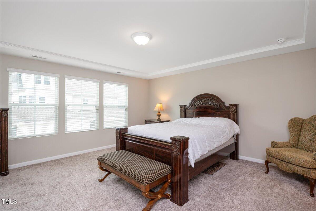 1416 Southpoint Trail Durham, NC 27713 - Photo 15 of 26 a bedroom with a bed chair and window
