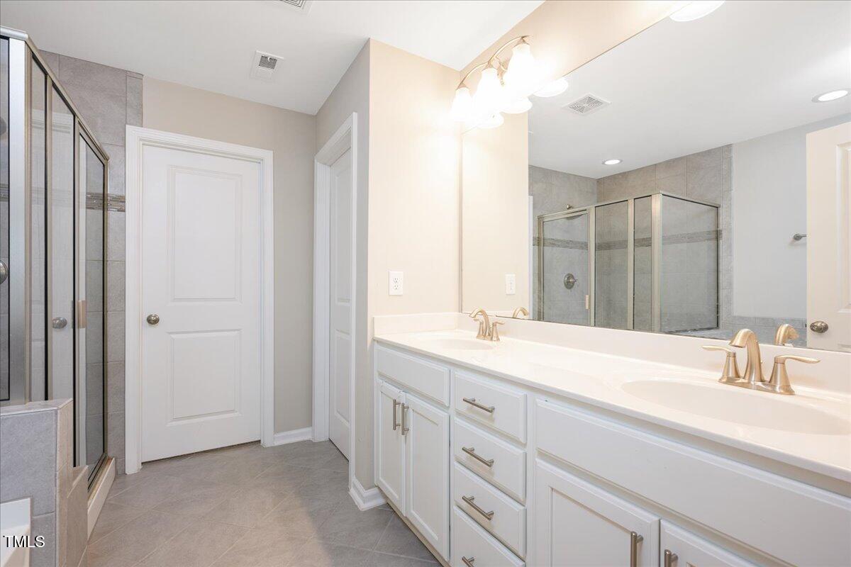 1416 Southpoint Trail Durham, NC 27713 - Photo 16 of 26 a bathroom with a sink and a mirror