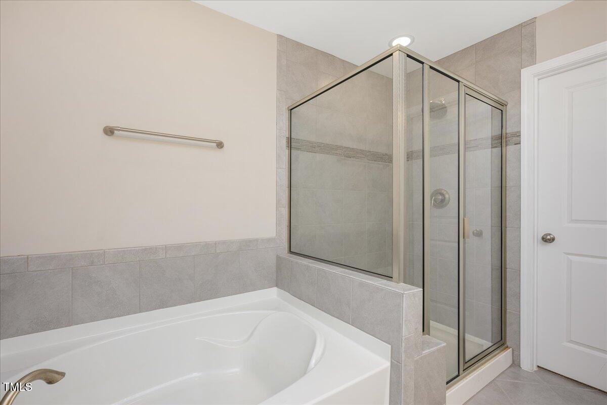 1416 Southpoint Trail Durham, NC 27713 - Photo 17 of 26 a bathroom with a bathtub and a shower