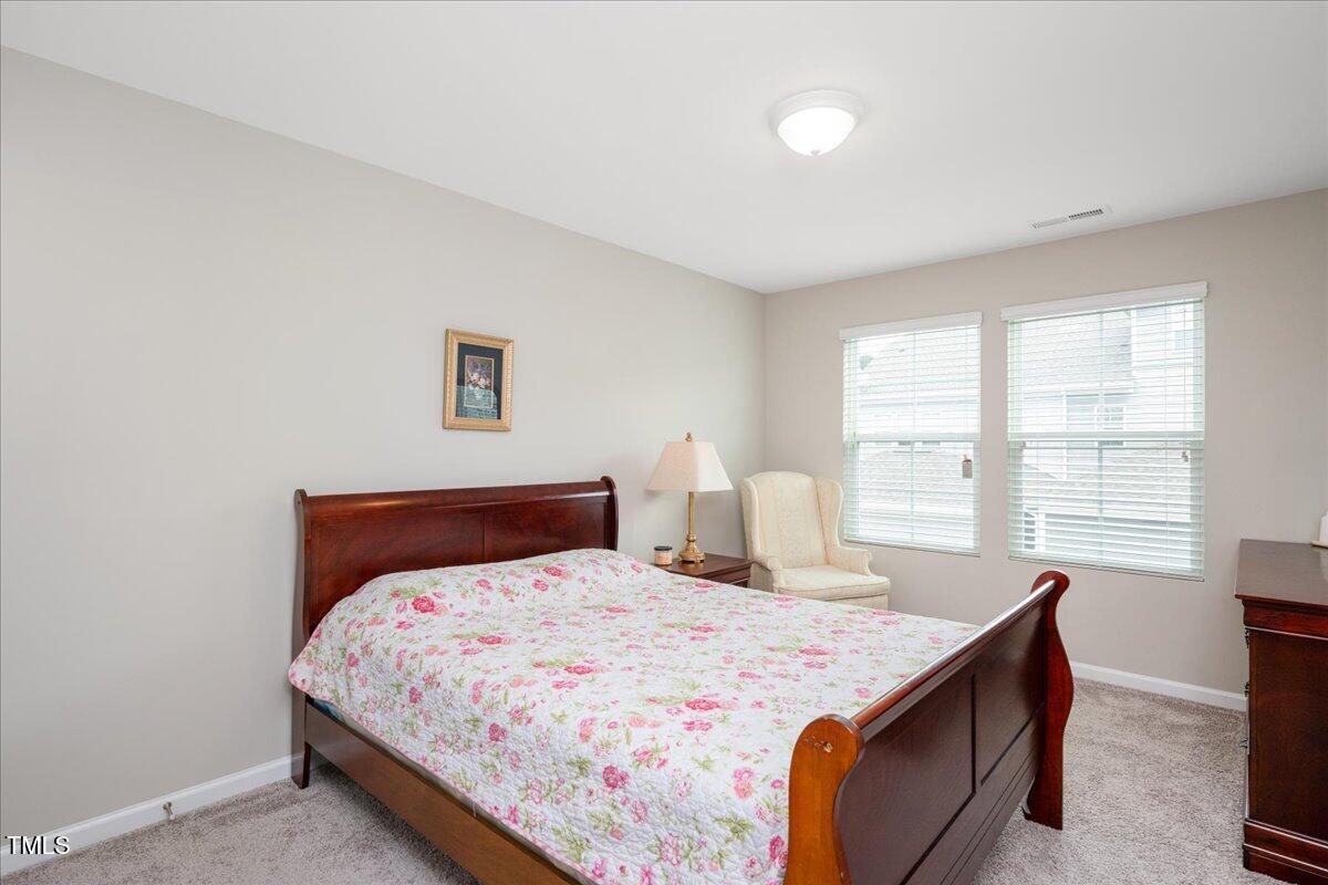 1416 Southpoint Trail Durham, NC 27713 - Photo 19 of 26 a bedroom with a bed and window