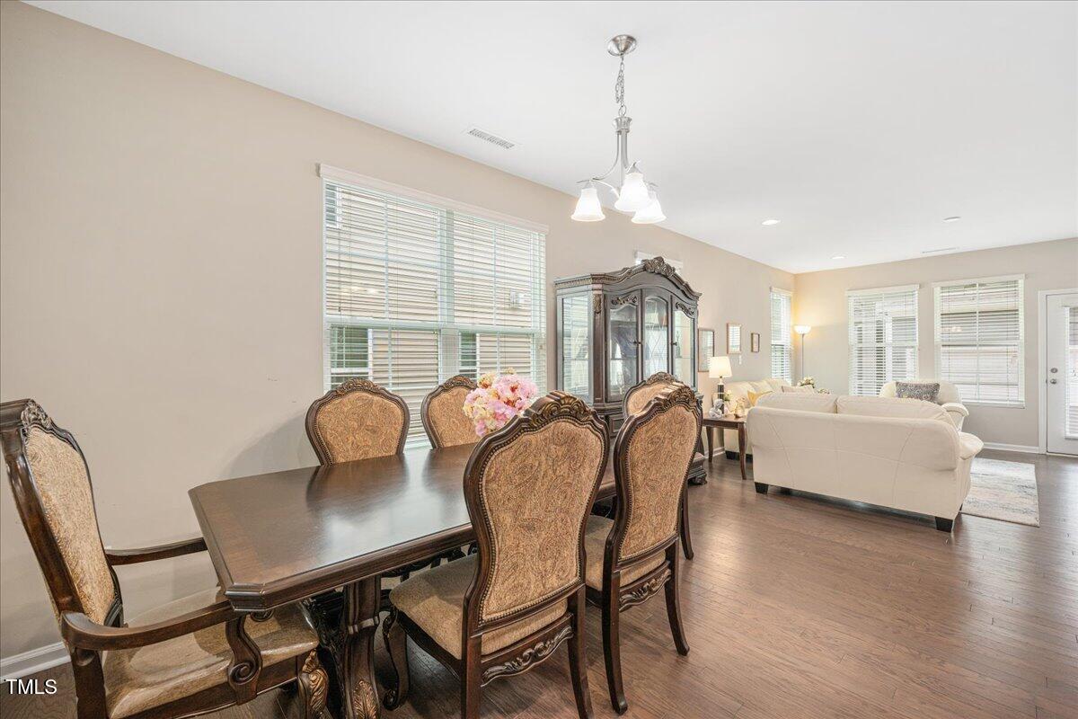 1416 Southpoint Trail Durham, NC 27713 - Photo 3 of 26 a view of a dining room with furniture window and wooden floor