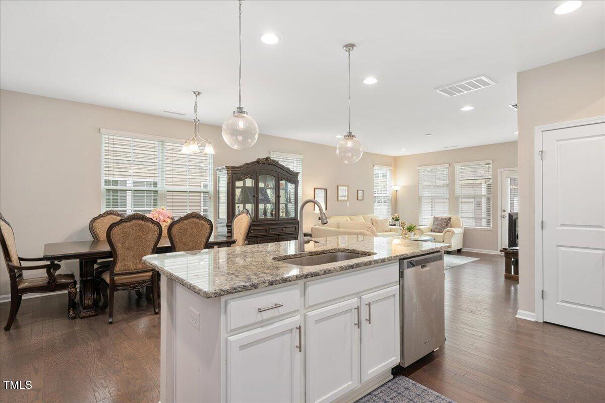 1416 Southpoint Trail Durham, NC 27713 - Photo 6 of 26 a kitchen with center island table and chairs