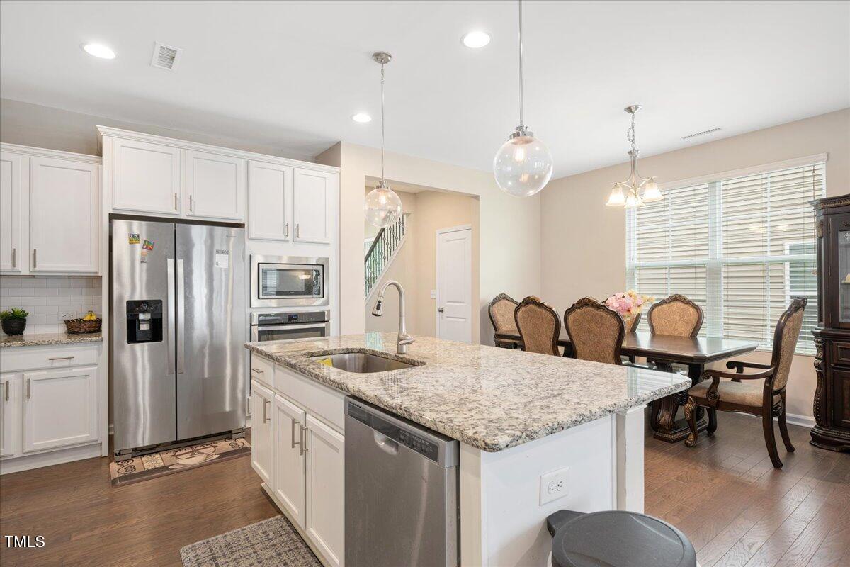 1416 Southpoint Trail Durham, NC 27713 - Photo 7 of 26 a kitchen with granite countertop cabinets and stainless steel appliances