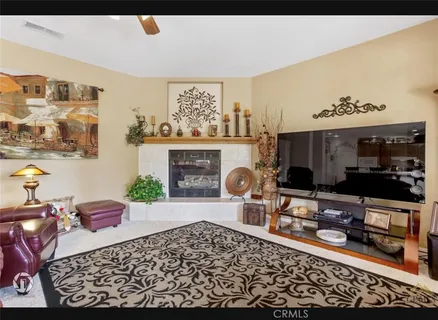 a living room with a couch dresser and a fireplace