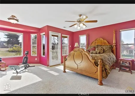 a bedroom with a bed and a large mirror
