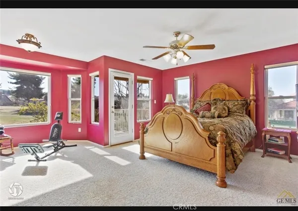 a bedroom with a bed and a large mirror