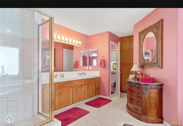 a spacious bathroom with a tub sink and mirror