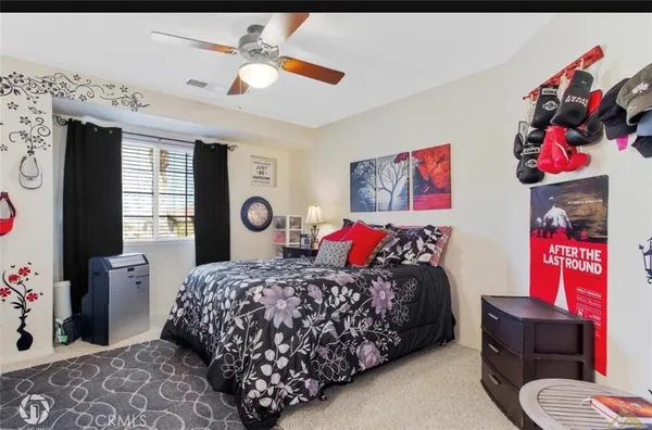 a bedroom with bed and a chandelier