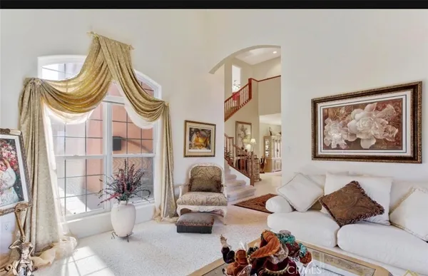 a living room with furniture and a painting on the wall