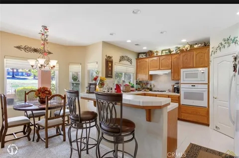 a kitchen with a sink and chairs