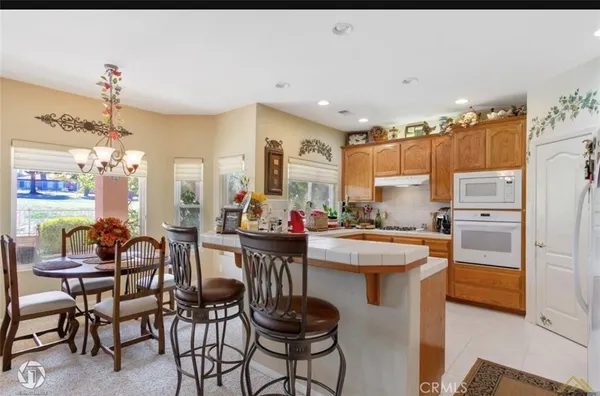 a kitchen with a sink and chairs