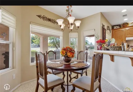 a view of a dining room with furniture and a chandelier