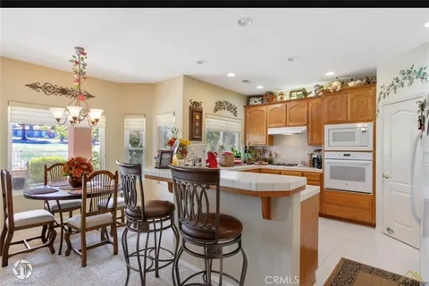 a kitchen with a sink and chairs