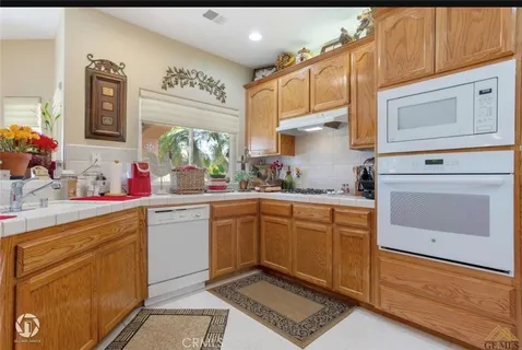 a kitchen with a sink cabinets and window
