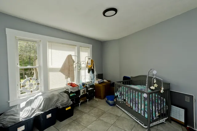 a bedroom with furniture and a window