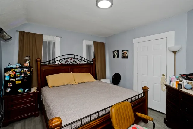 a bedroom with a bed and dresser
