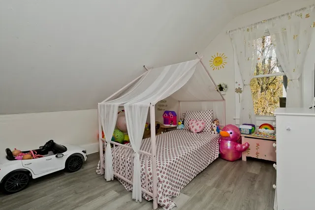 a bedroom with a bed and a window