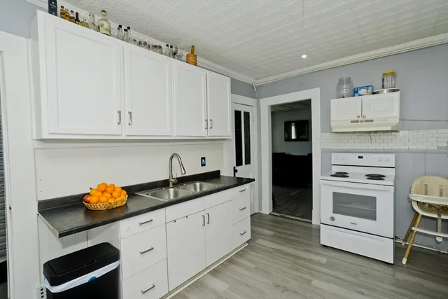 a kitchen with stainless steel appliances granite countertop a sink and cabinets