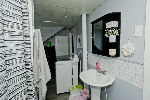a bathroom with a sink mirror and toilet