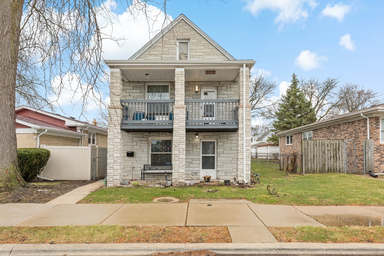 a front view of a house with a garden and plants