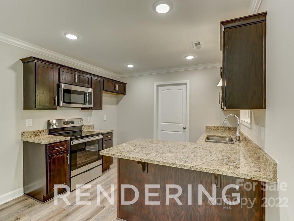 188 Washington Street York, SC 29745 - Photo 16 of 46 a kitchen with granite countertop kitchen island stainless steel appliances a sink stove top oven and granite counter tops