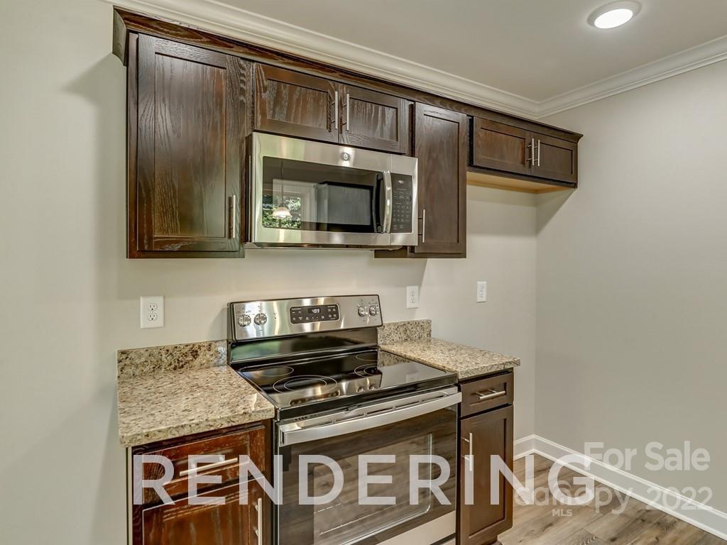 188 Washington Street York, SC 29745 - Photo 17 of 46 a kitchen with granite countertop cabinets stainless steel appliances and a wooden floor