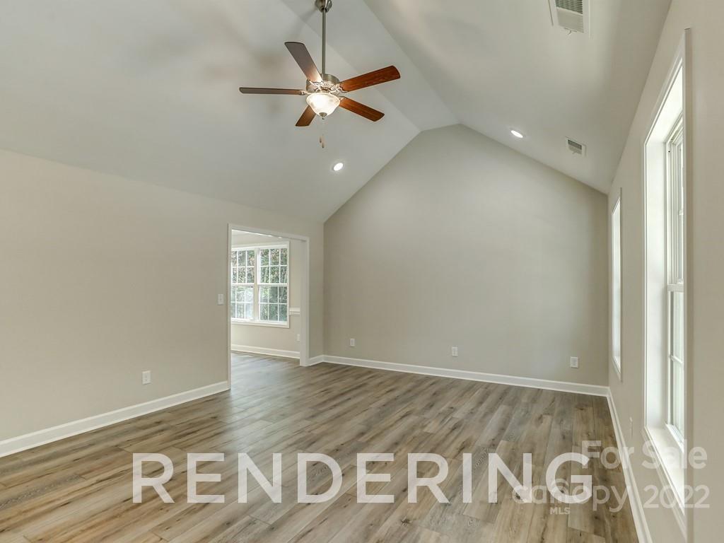 188 Washington Street York, SC 29745 - Photo 9 of 46 an empty room with wooden floor fan and windows