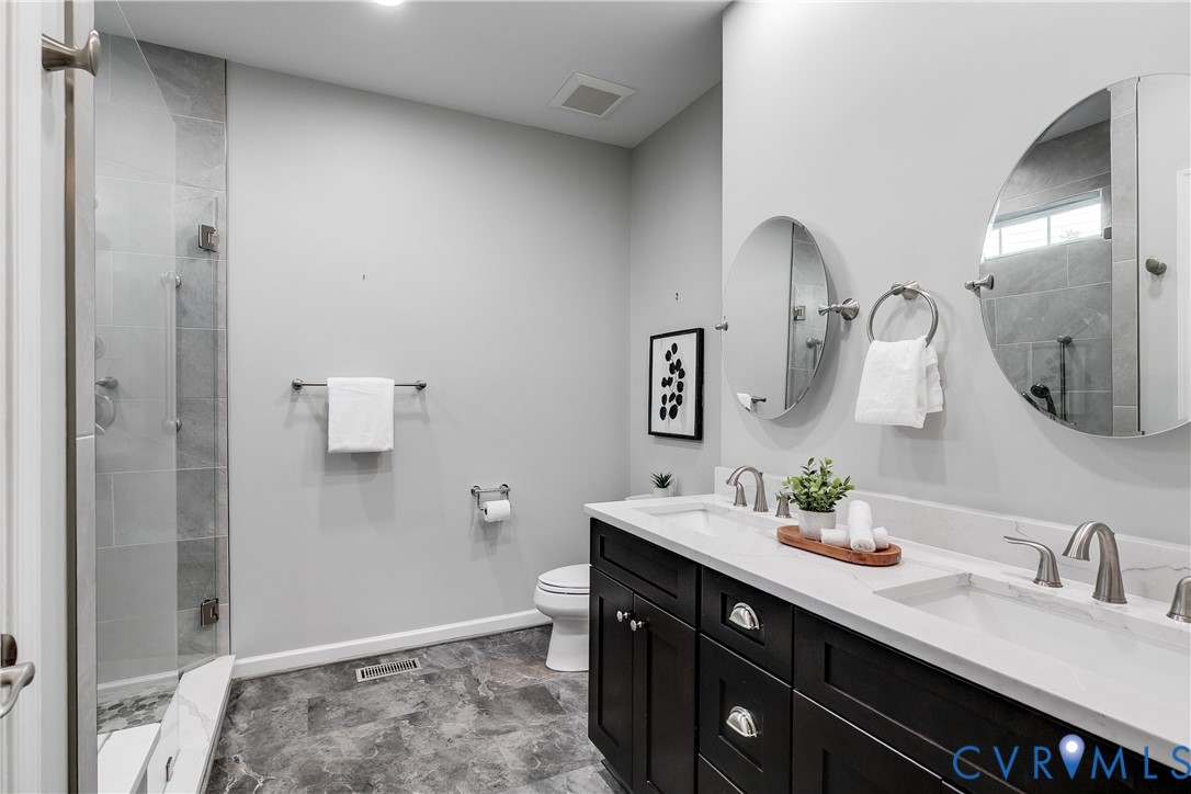 7538 South Franklins Way Quinton, VA 23141 - Photo 26 of 48 a spacious bathroom with a double vanity sink and a mirror