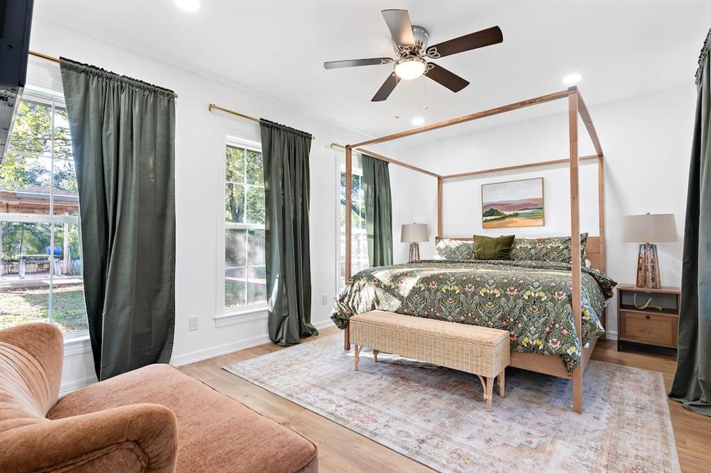 3210 Edna Avenue Waco, TX 76708 - Photo 11 of 18 a bedroom with a bed a couch and a large window