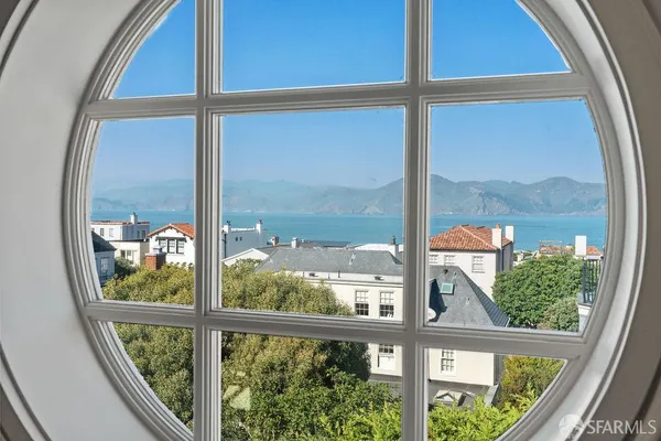 a view of a patio with couches and a potted plant on a table