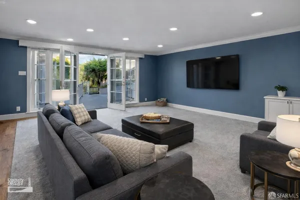 a view of a kitchen with furniture and wooden floor