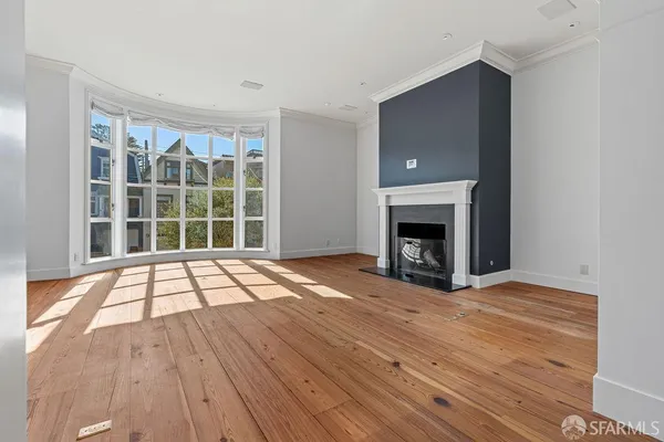 a view of a room with wooden floor and white walls