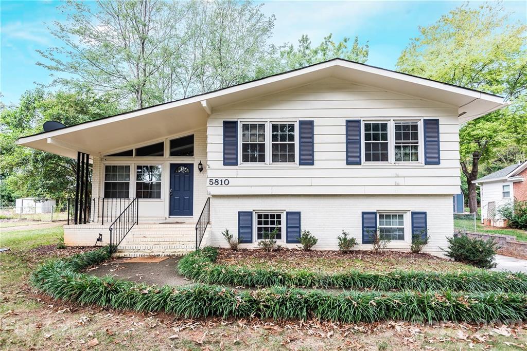 5810 Brookhaven Road Charlotte, NC 28210 - Photo 1 of 16 a front view of a house with garden