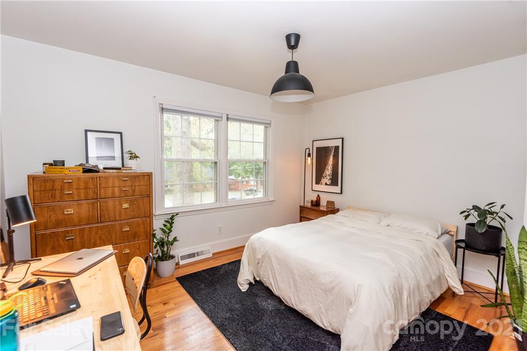 5810 Brookhaven Road Charlotte, NC 28210 - Photo 12 of 16 a bedroom with a bed and a chandelier