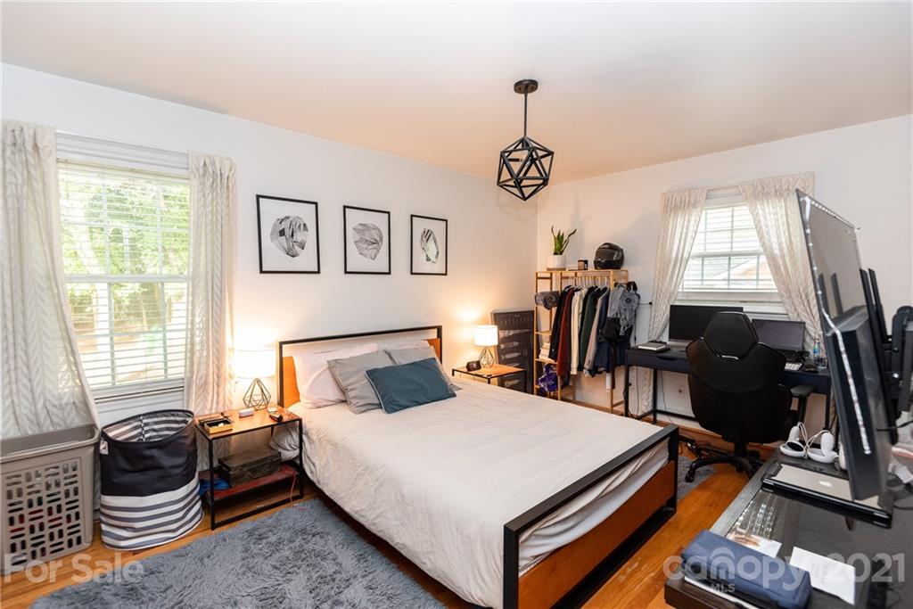 5810 Brookhaven Road Charlotte, NC 28210 - Photo 13 of 16 a bed room with a bed and a chandelier