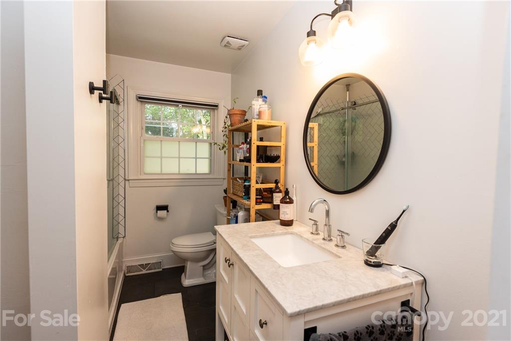 5810 Brookhaven Road Charlotte, NC 28210 - Photo 14 of 16 a bathroom with a sink and a mirror